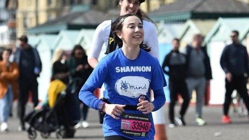Shannon Norman in blue t-shirt running a marathon