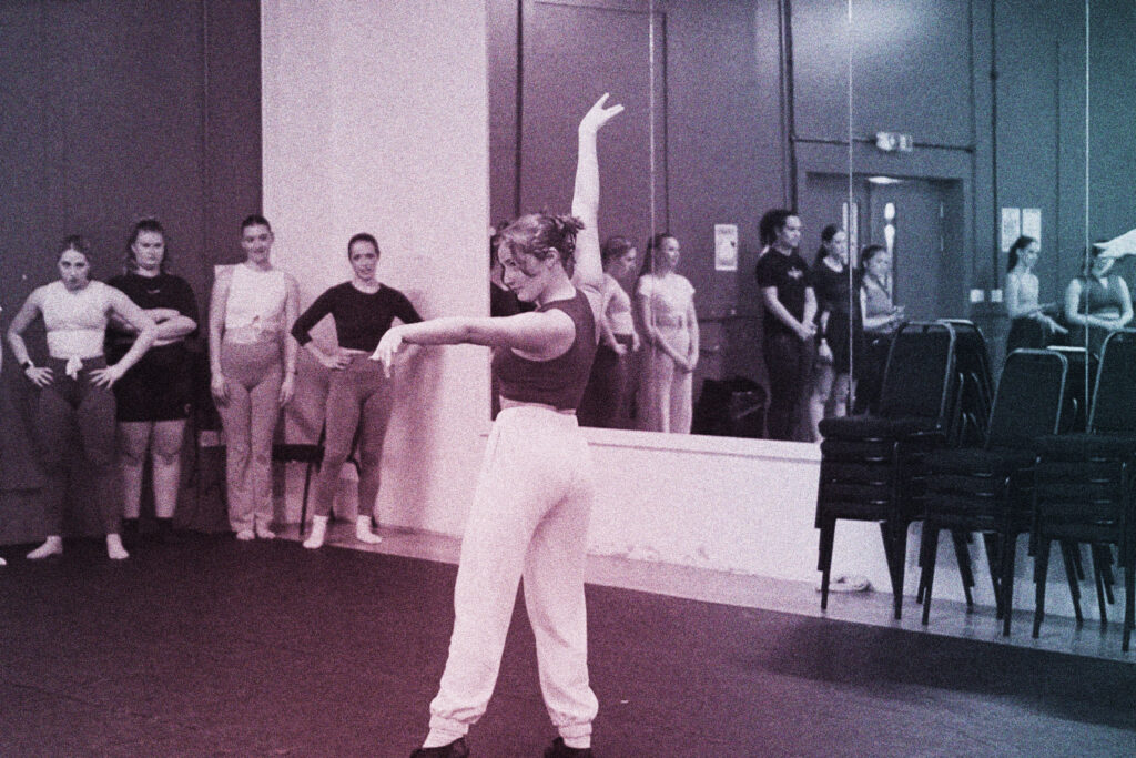 a student performs a dance in front of an agent panel